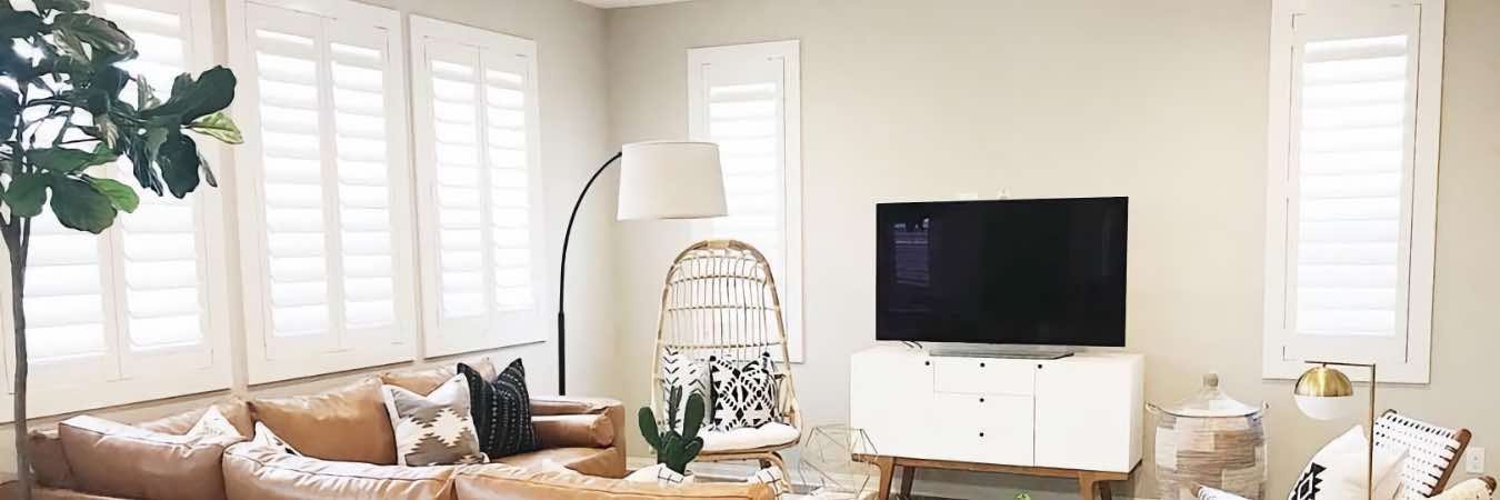 White Polywood shutters on living room windows of different sizes