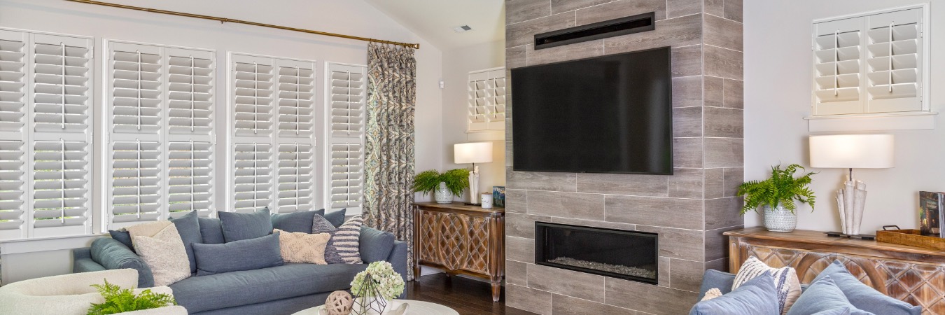 Interior shutters in Halawa family room with fireplace