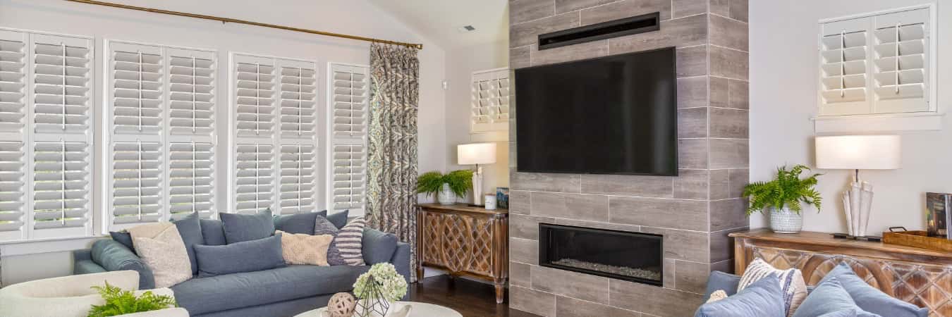 Interior shutters in Kahuku family room with fireplace