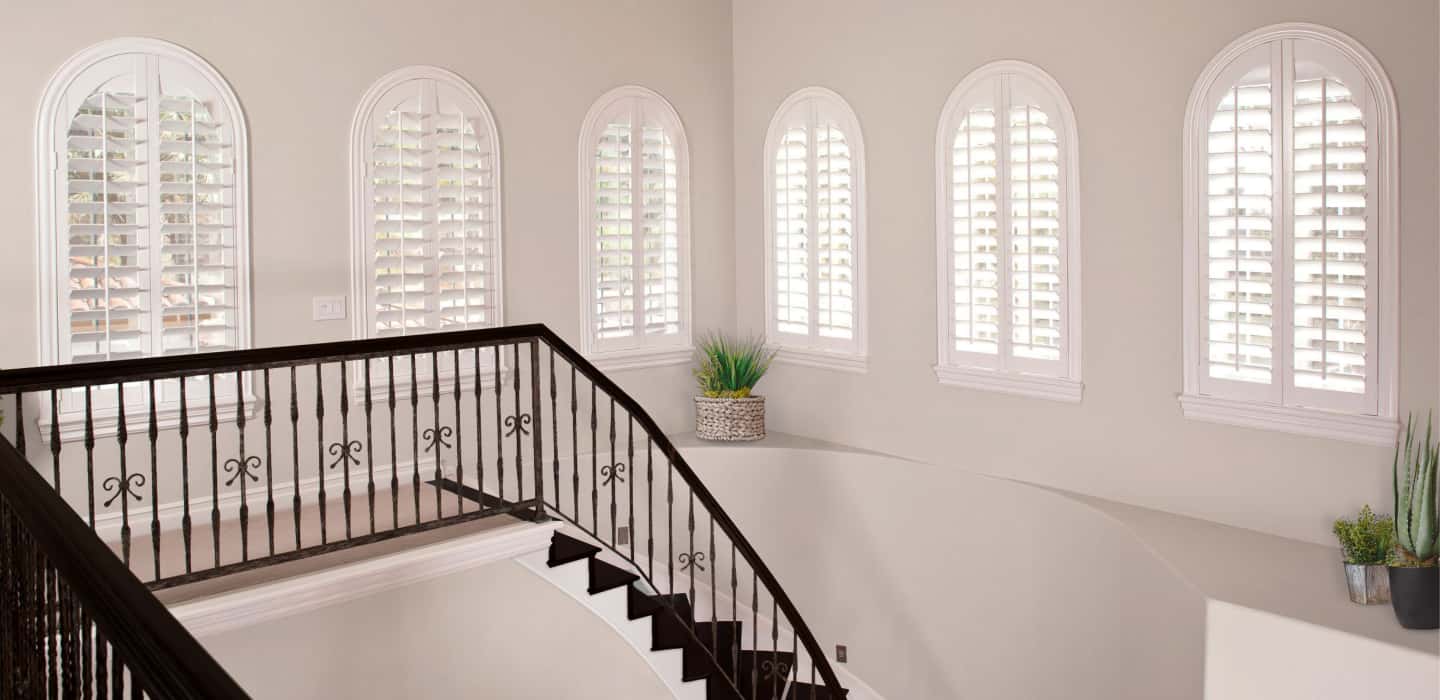 Custom-made coverings perfectly cover your window without sticking out and catching on the trim. Arched Plantation Shutters