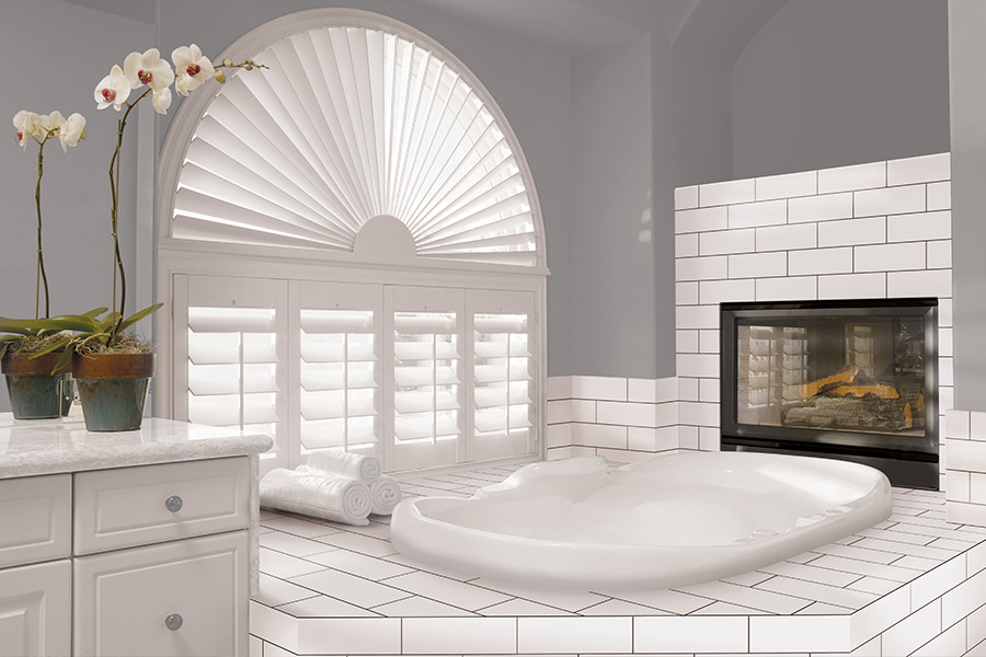 White Polywood shutters on an arched bathroom window