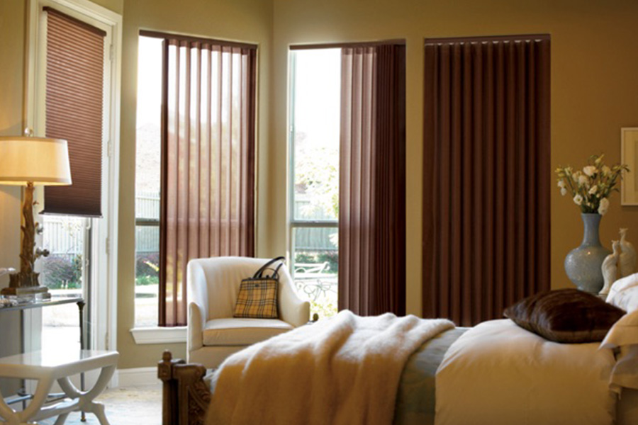 Maroon fabric vertical blinds inside a bedroom