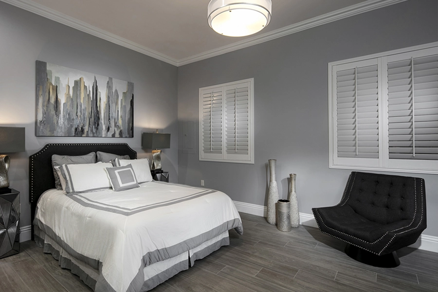 Close your custom Polywood shutters to beat the heat and keep your Honolulu bedroom cool. White Polywood shutters on bedroom windows